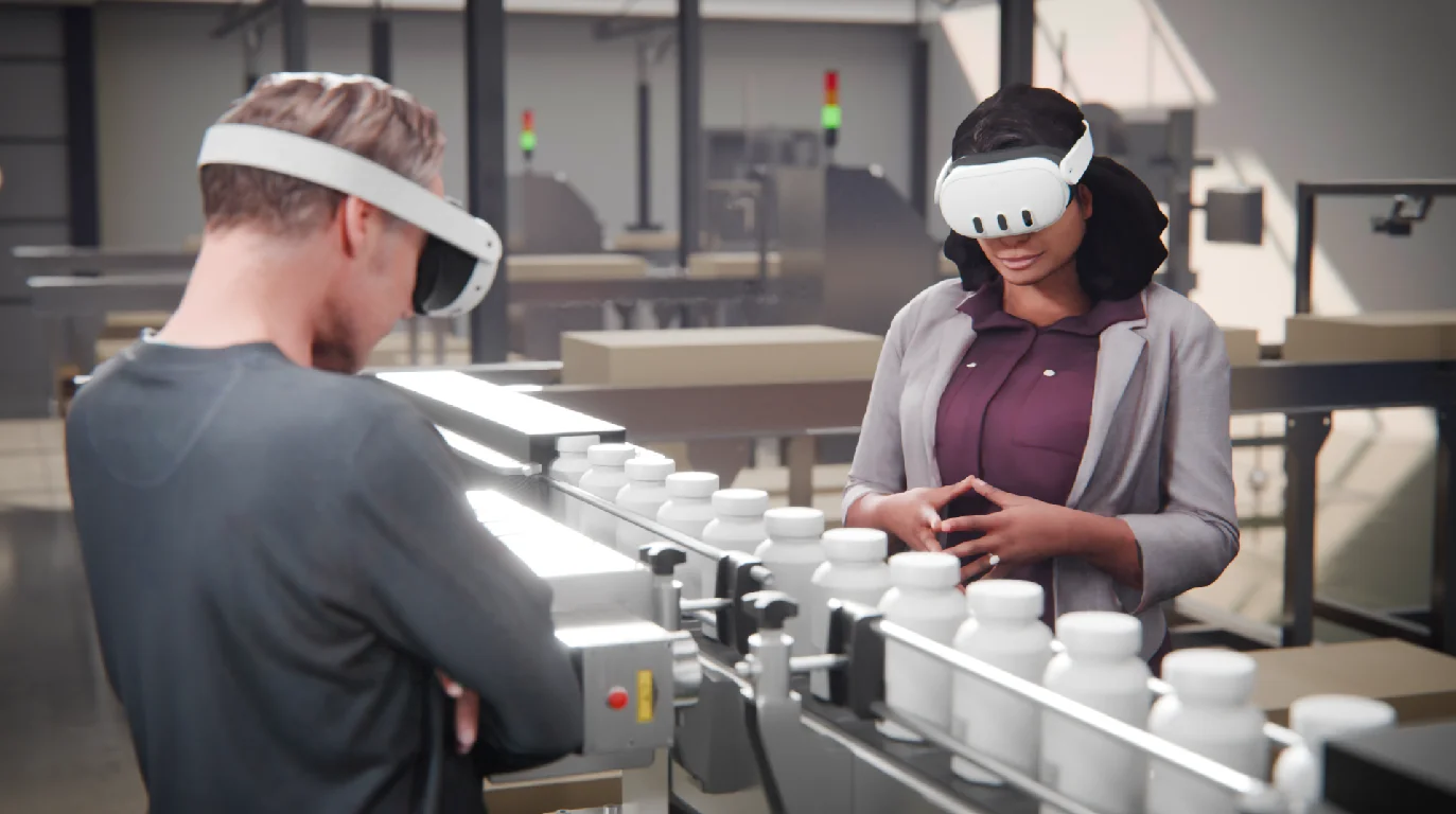Two people in VR headsets viewing a large piece of production line equipment in a factory setting using JoinXR.